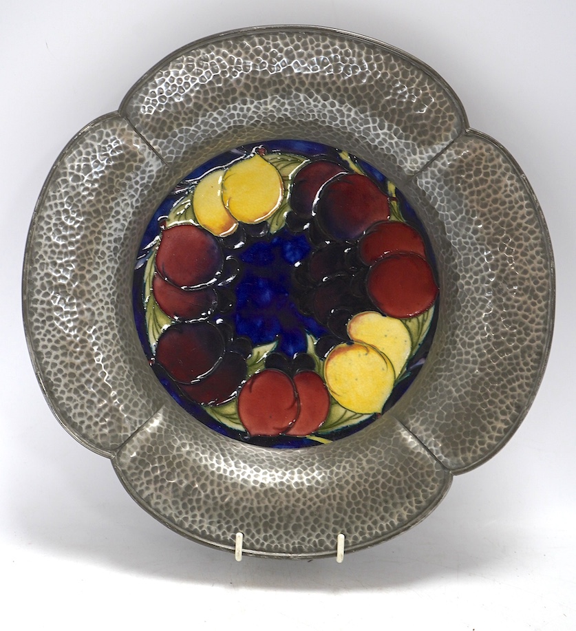 A Moorcroft for Liberty, Tudric wall plate decorated in the Wisteria pattern, stamped 01532, 28cm in diameter. Condition - good